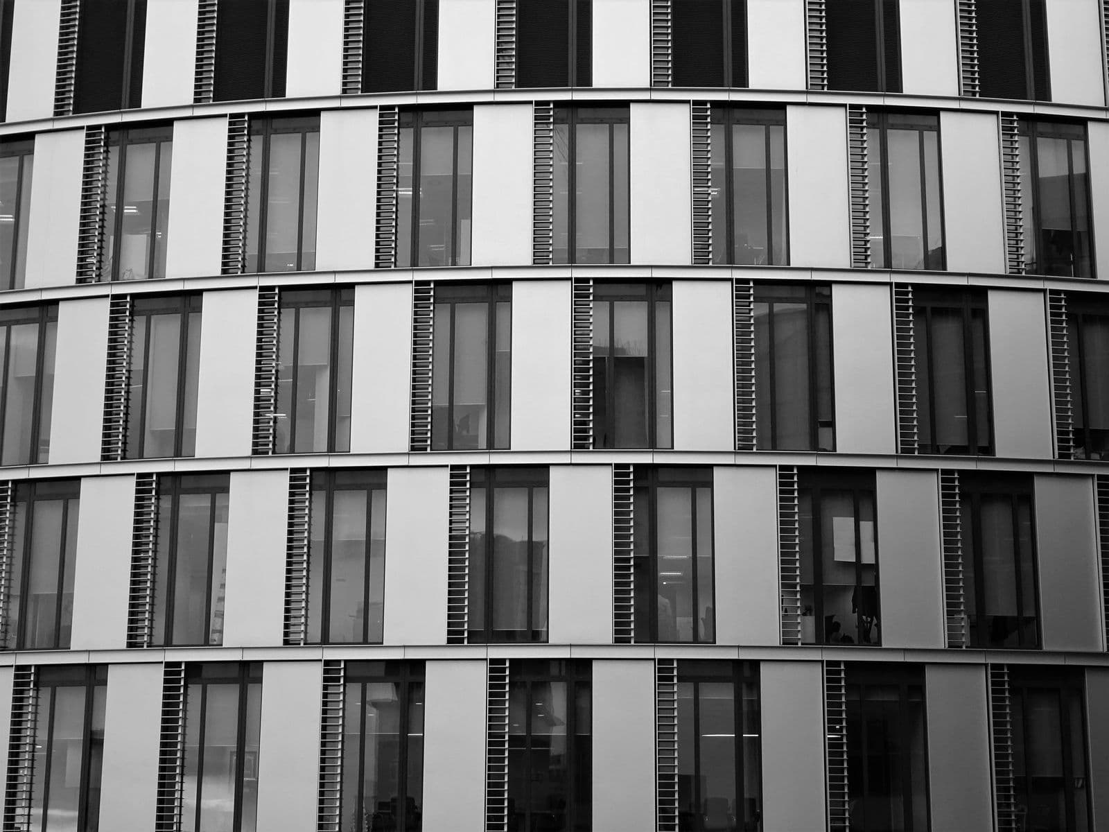The glass and steel facade of a modern office building, close up
