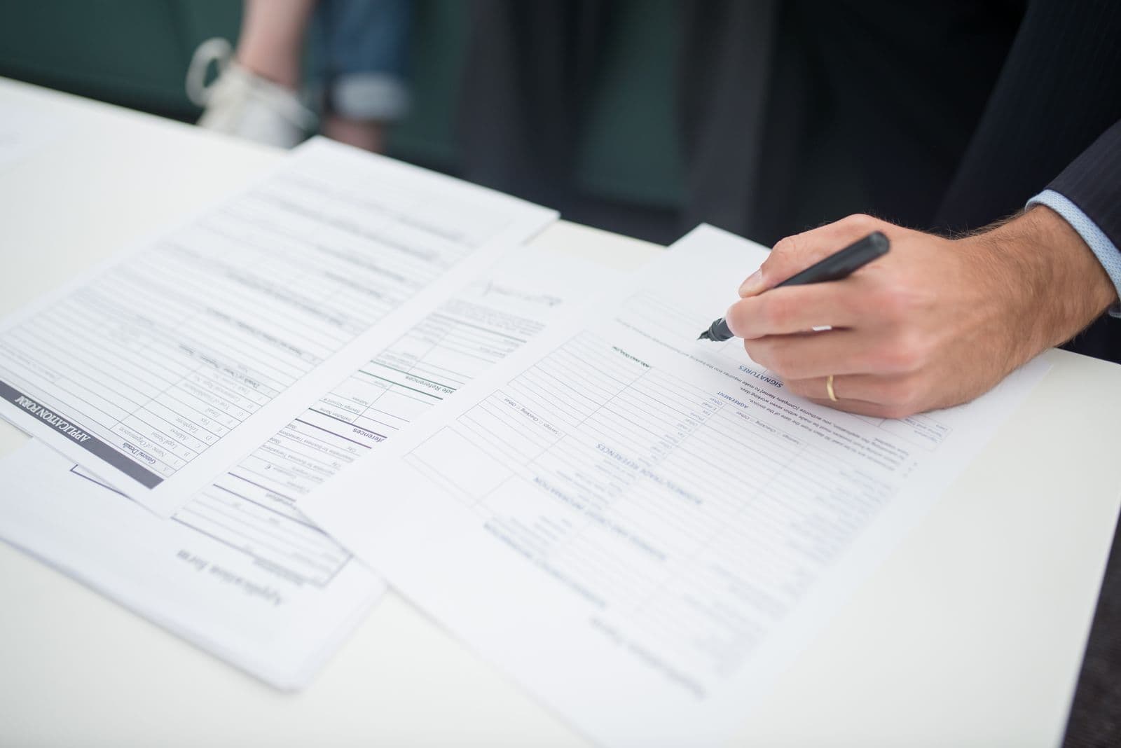 Forms being filled in at a desk