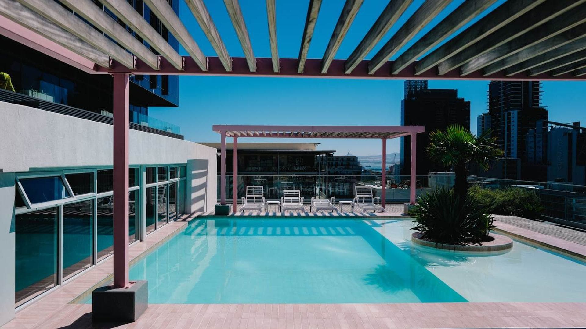 A rooftop pool deck overlooking the city