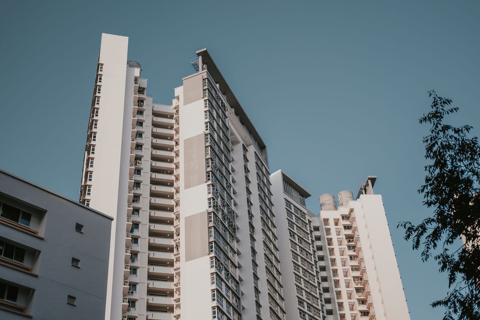 White residential towers rising against a clear blue sky