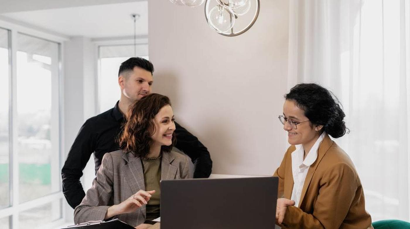 A couple in discussion with a property adviser